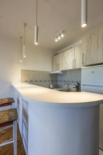 a kitchen with white cabinets and a white counter top at Old town Beauty Apartment with great view in Podgorica