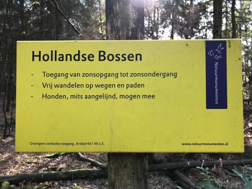 a yellow sign in the middle of a forest at Vijverhoef in Ulicoten