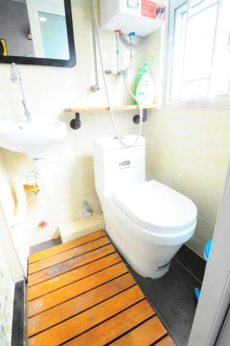 a bathroom with a toilet and a sink at Big Wave Travel in Hong Kong