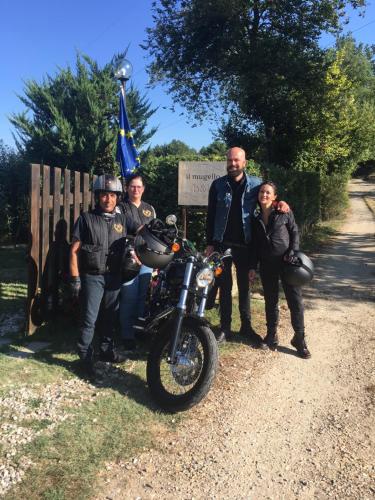 a group of people standing next to a motorcycle at Il Mugello B&B in Vicchio