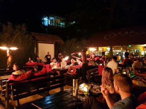 a group of people sitting at a restaurant at night at Ombak Dive Resort Perhentian Island in Perhentian Island