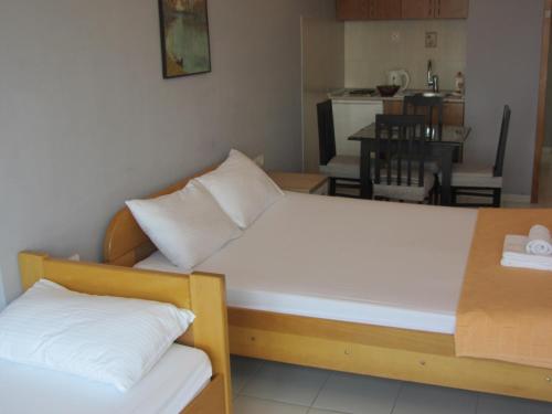 a bedroom with two beds and a dining room at Cernogoriya voyage in Rafailovici