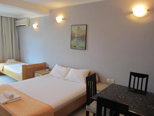 a hotel room with a bed and a table in it at Cernogoriya voyage in Rafailovici