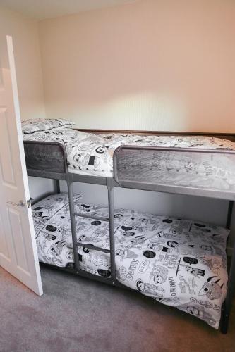 two bunk beds in a room with a mattress at Zoo House Chester in Chester