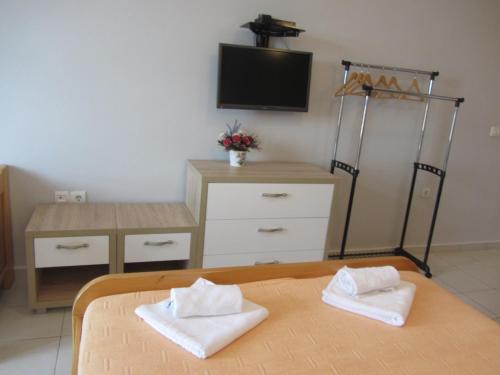 a bedroom with a bed and a desk and a television at Cernogoriya voyage in Rafailovici