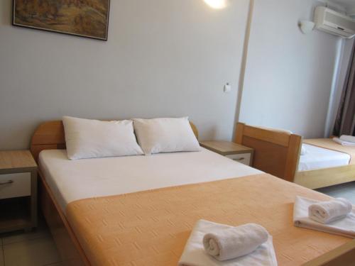 a small room with a bed with two towels on it at Cernogoriya voyage in Rafailovici