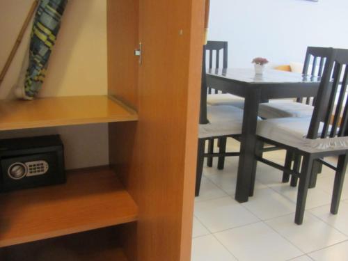 a dining room with a table and chairs in a room at Cernogoriya voyage in Rafailovici