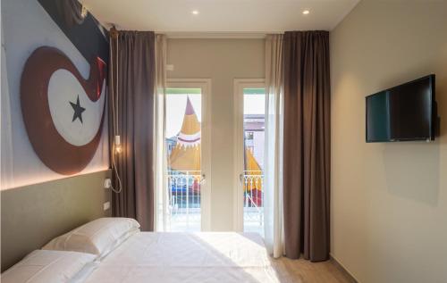 a bedroom with a bed and a television on the wall at porto canale b & b in Cesenatico