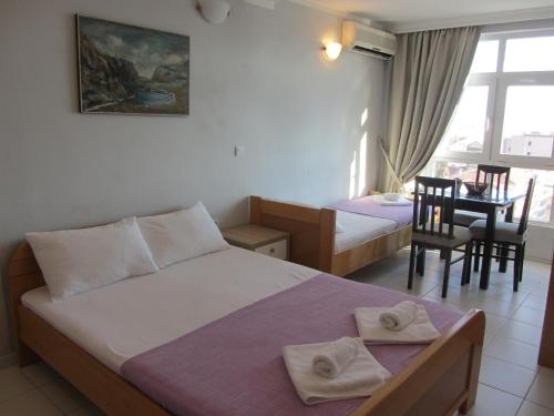 a hotel room with two beds and a dining room at Cernogoriya voyage in Rafailovici