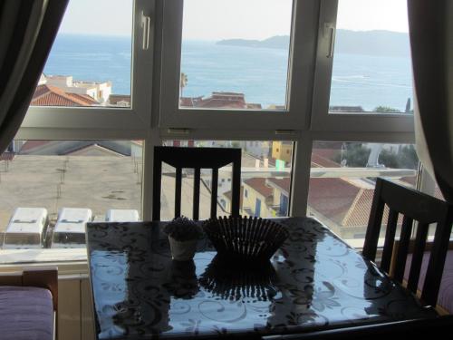 a table with a view of the ocean from a window at Cernogoriya voyage in Rafailovici