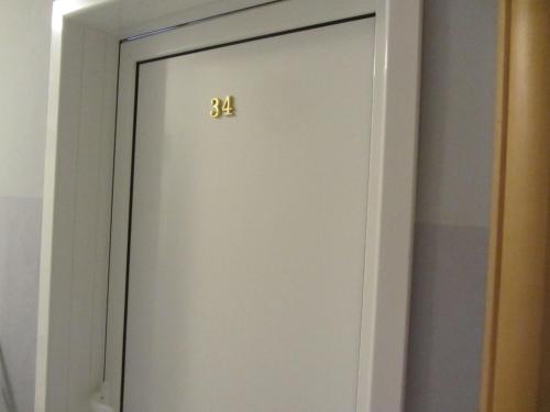 a white door with the number on it at Cernogoriya voyage in Rafailovici