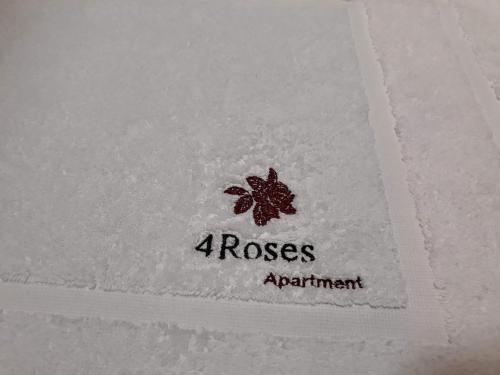 a napkin with a roses advertisement on it at 4Roses Apartments in Smokovce