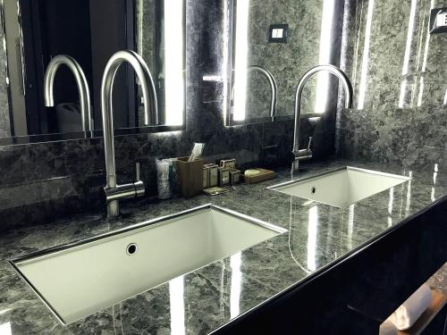 a bathroom with two sinks and two mirrors at VILLA MARRONE - Relais - in Marsala