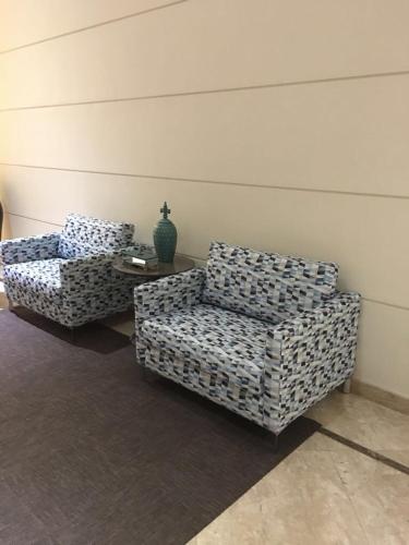 two chairs and a table in a room at Anitta 2 in Sao Paulo