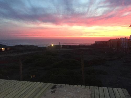 a sunset from the balcony of a house at PUPUYA LODGE cabaña A, Matanzas in Matanzas