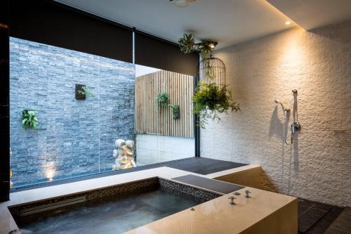 a bathroom with a bath tub with a large window at Shu Jia Motel in Taichung