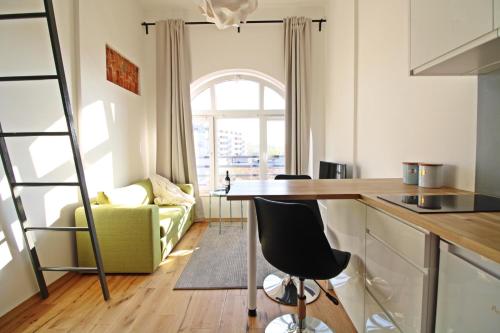 a kitchen with a table and a couch in a room at Aparthotel Tectum TectumApartments in Wrocław