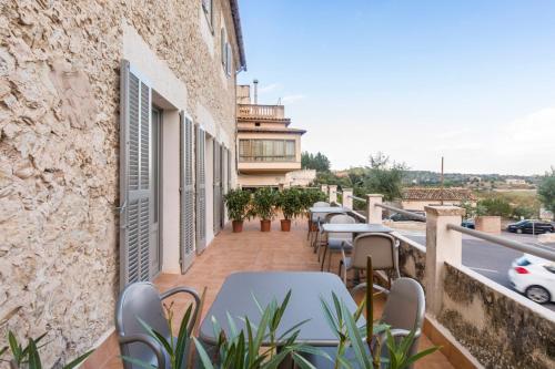 a balcony with tables and chairs on a building at Son Gris in Selva