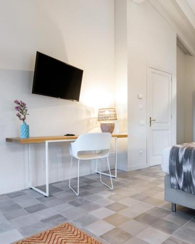 a room with a desk with a television on a wall at Son Gris in Selva