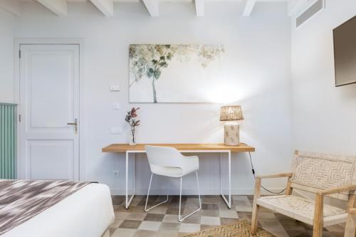 a bedroom with a desk and a bed and a chair at Son Gris in Selva