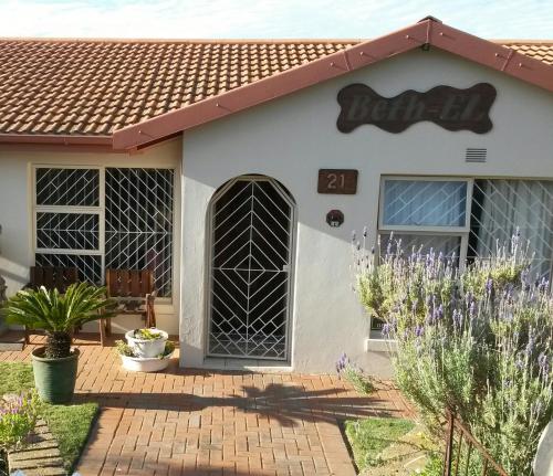 a house with a sign on the front of it at Beth-El in Mossel Bay
