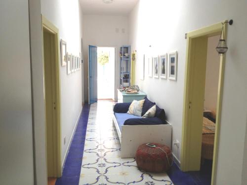 a hallway with a couch and a room with a door at Villa Lucky in Punta Prosciutto