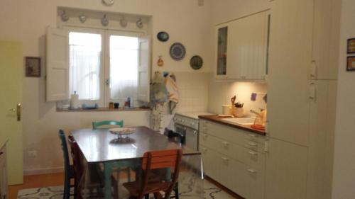 a kitchen with a table and chairs and a window at Villa Lucky in Punta Prosciutto