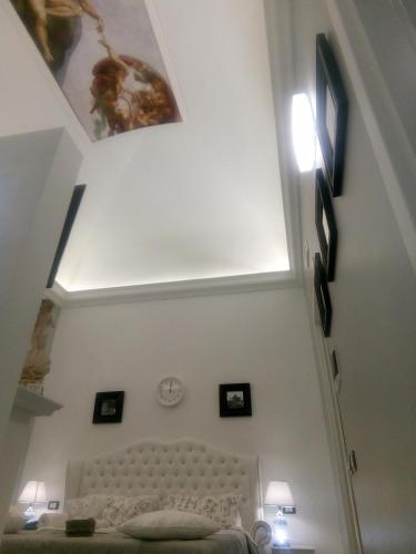 a bedroom with a bed and a ceiling with pictures at Barberini Dream in Rome