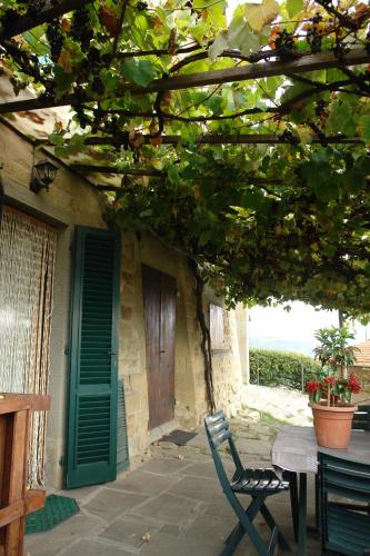 a patio with a table and a green door at La Casina in Stia