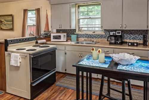 a kitchen with a stove and a table at Silver Heart Inn & Cottages in Independence