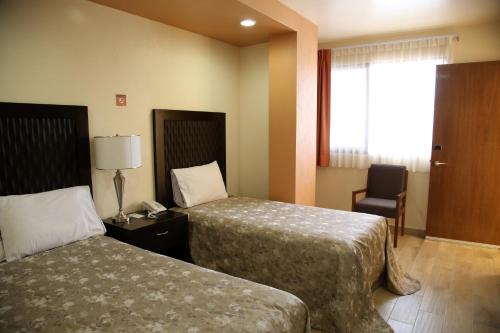 Postel nebo postele na pokoji v ubytování Hotel Plaza Bernal