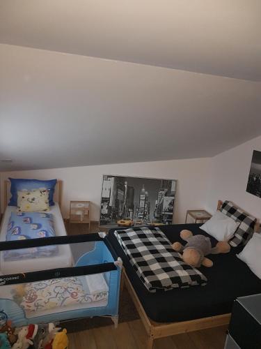 a bedroom with two beds and a bunk bed at Apartmány Tylovice in Rožnov pod Radhoštěm