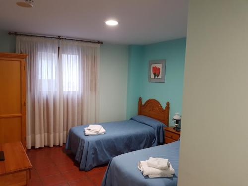 Posteľ alebo postele v izbe v ubytovaní HOSTAL ITXASO-ENEA