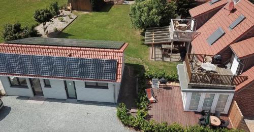 an overhead view of a house with a solar roof at Die 5 Ferienwohnungen der Familie Weber in Fehmarn