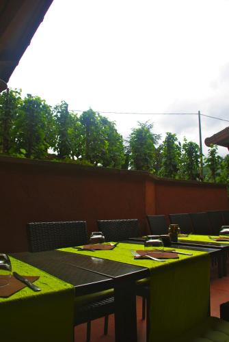 a room with tables and chairs with green table cloth at Logis Hôtel Burnichon in Tarare