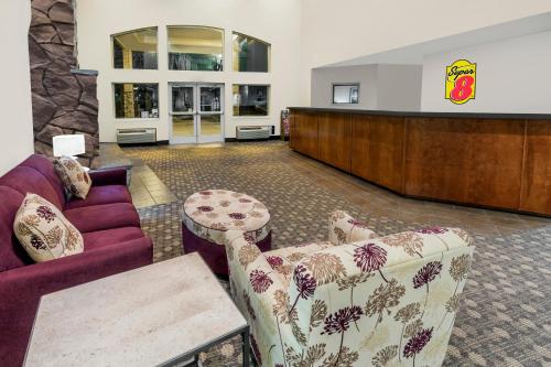 a waiting room with a couch and a table at Super 8 by Wyndham Central Pt Medford in Central Point