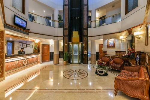 a lobby of a hotel with chairs and a table at The Paradise By Tunga in Mumbai