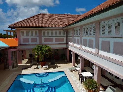 an aerial view of a building with a swimming pool at Kamerlingh Villa in Oranjestad