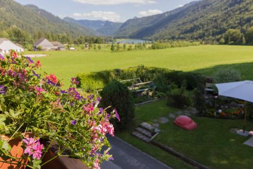 a view from the balcony of a house with flowers at Ferienwohnung Claudia in Faistenau
