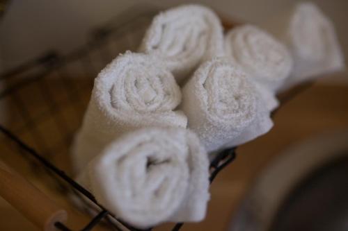 a group of white towels on a rack at Tslil Suite in Yeroẖam