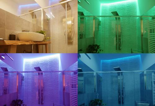 La salle de bains est pourvue de parois en verre colorées et d'un lavabo. dans l'établissement Pisetzky-Spadaro Apartments - Vegezio Roma, à Rome