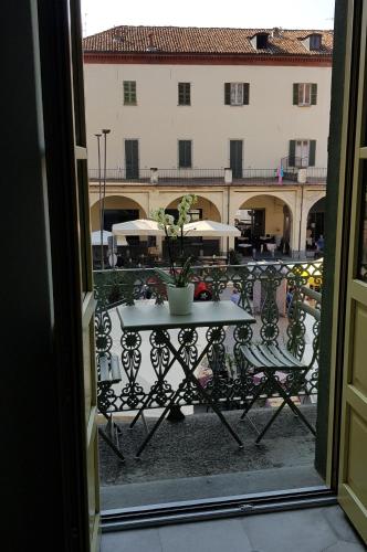 a view of a table and chairs from a window at Appartamento Pertinace Centro Storico Alba in Alba