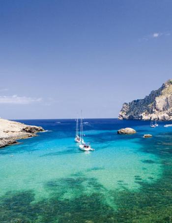 a group of boats floating in the water at Residencia Santiago Mallorca in Cala Figuera