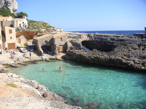 a group of people swimming in a body of water at Residencia Santiago Mallorca in Cala Figuera