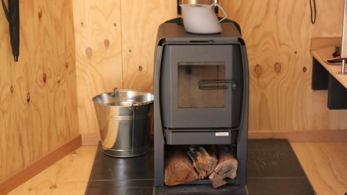 a oven with a turkey inside of it in a kitchen at BAY OF FIRES ECO HUT off grid experience at Binalong Bay in Binalong Bay