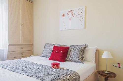 a bedroom with a bed with a red candle on it at GMApartments stylish 2 rooms flat White House in Moscow