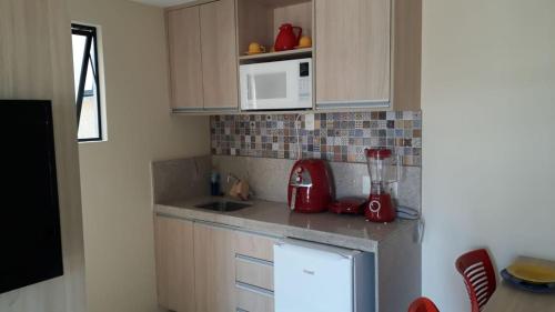 a kitchen with a red blender on a counter at Flat no Aldeia das Águas (Deluxe) in Barra do Piraí