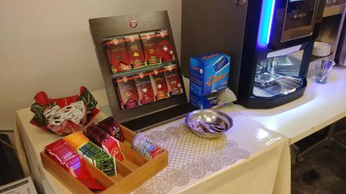 a table topped with a counter with a refrigerator and snacks at Hotel Vittoria in Genova