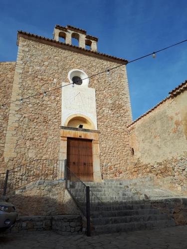 a large brick building with a door and stairs at Senda Caimari in Caimari