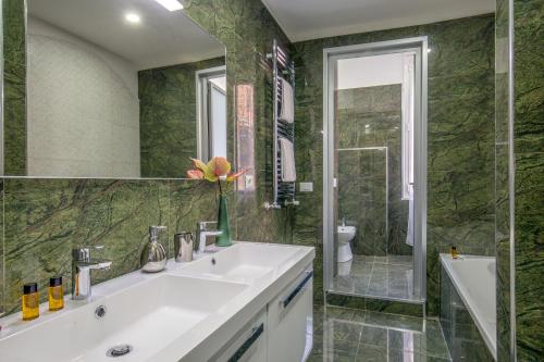 a bathroom with a white sink and a shower at Well Done Montebello in Rome